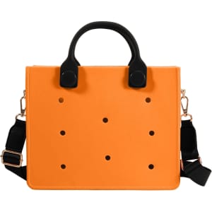 An orange casual tote bag with black handles and a detachable strap, featuring evenly spaced holes throughout.