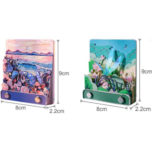 A 3D paper-cut sculpture notepad featuring colourful landscapes with butterflies and flowers, in blue and green hues.