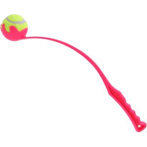 A pink ball thrower with a curved arm and a tennis ball attached at the end. It has a textured handle for grip.