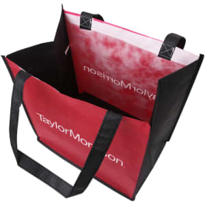 A tall non-woven tote bag featuring red and black colours, with sturdy handles and a logo inside.