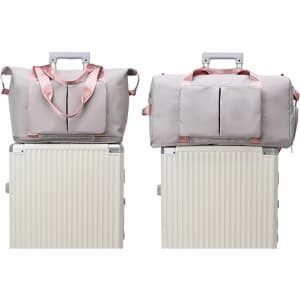 A grey foldable sports duffle bag with pink accents placed on a luggage trolley. The bag features a logo.