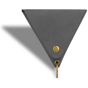 A triangular grey coin holder with a brass button and keyring attachment. It has a sleek, minimalist design.