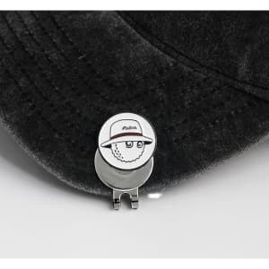 A 25mm golf ball marker featuring a cartoon sheep wearing a hat, attached to a silver clip on a dark cap.
