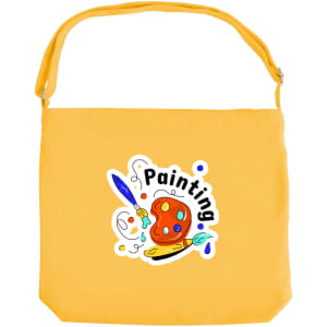 A yellow canvas tote bag with a long strap and a logo featuring a paint palette and brush.