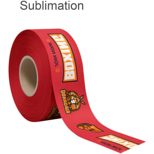A red ribbon roll featuring bold graphics and branding designs. The ribbon is unspooled partially from its core.