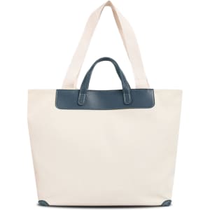 A cream canvas bag featuring a navy leather handle and straps, with a simple design and a logo present.