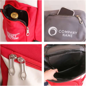 A red backpack with various compartments, including a bottle holder, a phone pocket, and zipper details.
