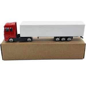 A red truck toy with a white trailer, displayed on a brown cardboard box. The truck features wheels and branding.