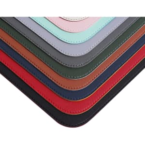 A collection of PU leather desk mats in various colours, featuring stitched edges and a smooth finish.