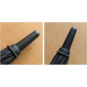 A black umbrella tip with a black plastic cap, featuring a textured grip and a small decorative band.