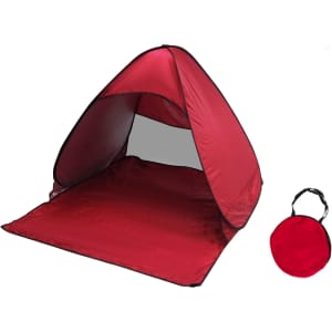 A red pop-up beach tent featuring a spacious interior and a matching carry bag.