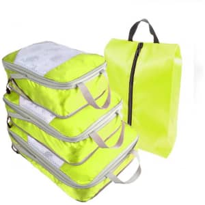 Bright yellow travel packing cubes in various sizes, featuring mesh panels and handles for easy carrying.