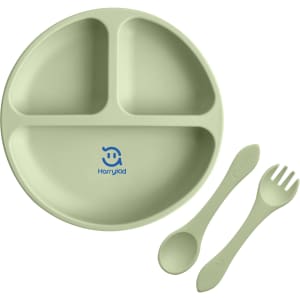 A green silicone kids suction plate featuring three sections, accompanied by a spoon and fork, with a logo.