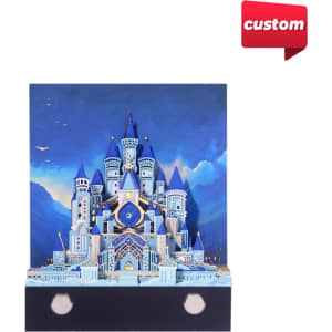 A 3D paper art notepad in blue and white, featuring a detailed castle design with towers and a scenic backdrop.