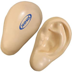 An ear-shaped stress reliever in a beige colour, featuring a logo on its surface.