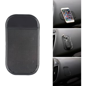 A black dashboard mat with a textured surface, designed to hold small items like phones and keys in place.