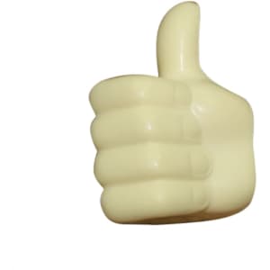 A cream-coloured, thumb-shaped stress reliever with a raised thumb design and a smooth surface.