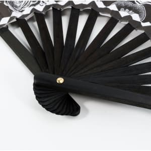 An 8-inch bamboo fabric hand fan with a black wooden frame and decorative fabric design featuring shades of white and black.