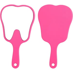 A pink tooth-shaped face mirror with a handle, featuring a reflective surface on one side and a solid backing on the other.