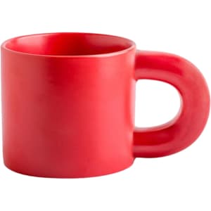 A red ceramic coffee mug with a unique handle design and a glossy finish. The mug features a logo.