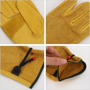 A pair of yellow cowhide gardening gloves featuring a wrist cinch detail and a brand logo.