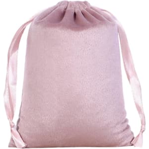 A pink silk velvet drawstring bag with satin ribbons for closure. It has a smooth, soft texture.