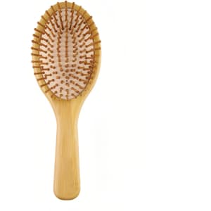 A bamboo hair comb with a wide paddle design and rounded teeth, showcasing a natural finish and smooth texture.