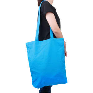 A bright blue long handle cotton bag is held by a person, featuring an unbranded design.