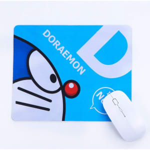 A blue mouse mat featuring a cartoon character and a white computer mouse on a white background.