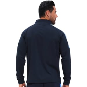 A navy blue raglan jacket featuring a high stand-up collar and quarter-zip design, with a subtle logo.