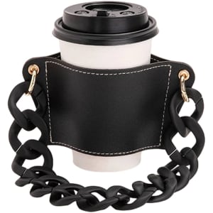 A drink bottle holder in black leather with a chunky acrylic strap, featuring a circular cutout for the bottle.