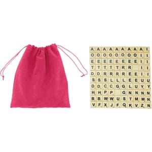 A pink drawstring bag alongside a set of beige letter tiles arranged in a grid pattern.