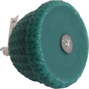 A teal hat-shaped candle with a textured surface, featuring a metallic base. Includes a branding label.