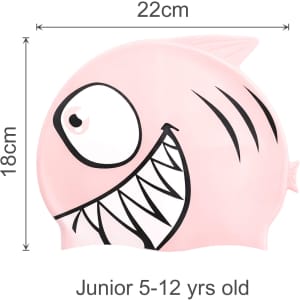 A pink silicone swim cap featuring a fish design with a smiling face and sharp teeth. Measures 22cm by 18cm.