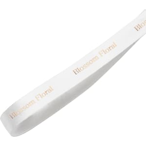 A satin polyester ribbon in white with a gold branding logo printed along its length.