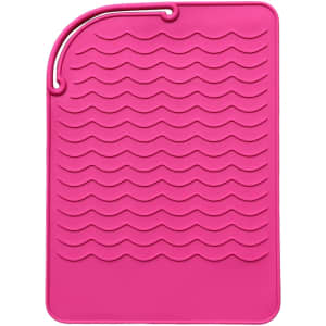 A pink silicone pad with a wave texture, featuring a loop for hanging. It has a logo in one corner.