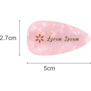 A teardrop-shaped, iridescent hair clip in pink and gold with a logo, measuring 5 cm by 2.7 cm.