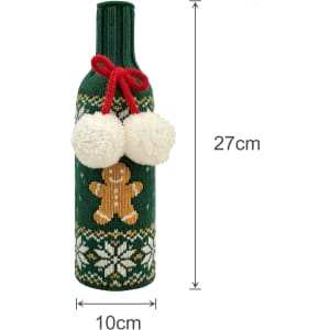 A drink bottle is wrapped in a green knitted sleeve, featuring a gingerbread man and white pom-poms.