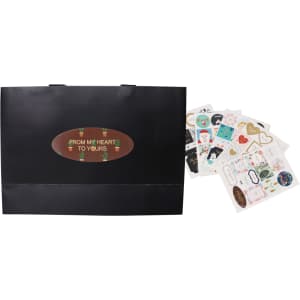 A medium black paper bag with flat handles, accompanied by assorted decorative stickers.