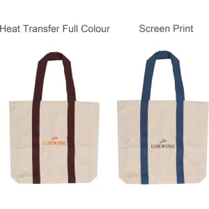 Two canvas tote bags are displayed: one with maroon handles and lettering, and another with blue handles and lettering. Both are beige.