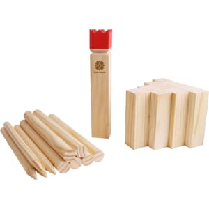 A wooden Kubb set featuring light-coloured pieces, including eight cylindrical pins and a king piece with a red crown.