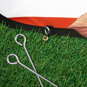 An oval-shaped pop-up banner with a grass-like base, featuring attachment hooks and pegs.