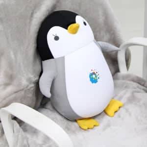 A penguin-shaped plush travel pillow in black, white, and yellow, featuring a small logo on its belly.