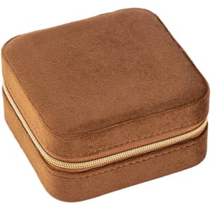 A velvet jewellery organiser in a square shape, featuring a soft brown finish and a gold zipper.