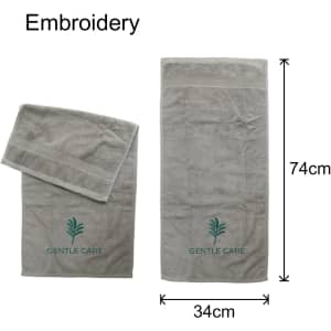 Embroidered cotton hand towels in grey, featuring a logo and two sizes: one large and one small.