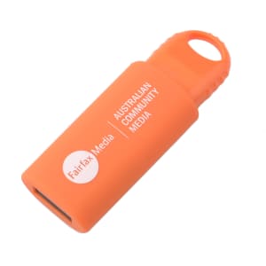 An orange flash drive with a keyring hole and a logo on the side.