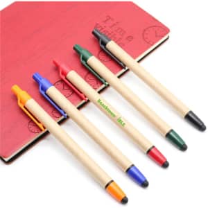 A collection of five stylus pens in blue, red, green, black, and orange placed on a red notebook. Each pen features a touch head.