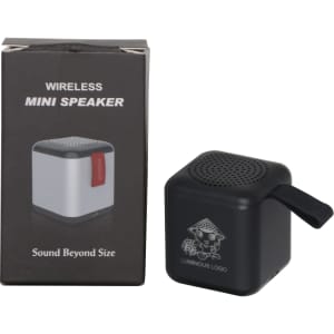 A Bluetooth speaker in black and silver, placed beside its packaging featuring a logo and product details.
