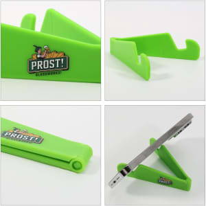 A V-shaped phone stand in vibrant green, featuring a logo, designed for holding devices securely.