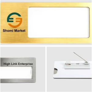 A rectangular reusable metal name badge in gold and silver finishes, featuring a logo and a white insert area.